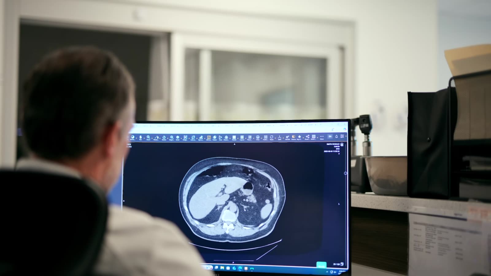 A clinician reviewing a CT study